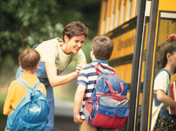 Mom putting son on bus